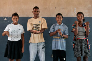 A mixed group of individuals demonstrating sign language